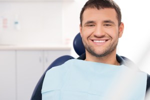 smiling man in dental chair